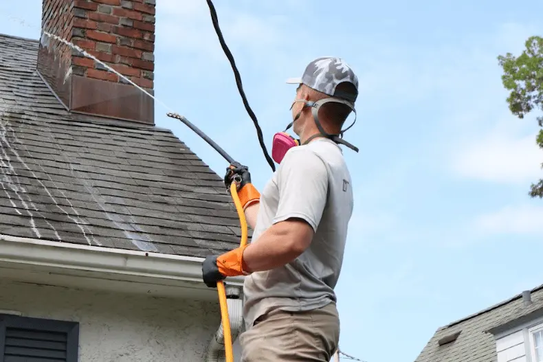 Stow Power Washing professional performing gentle roof washing service in Stow