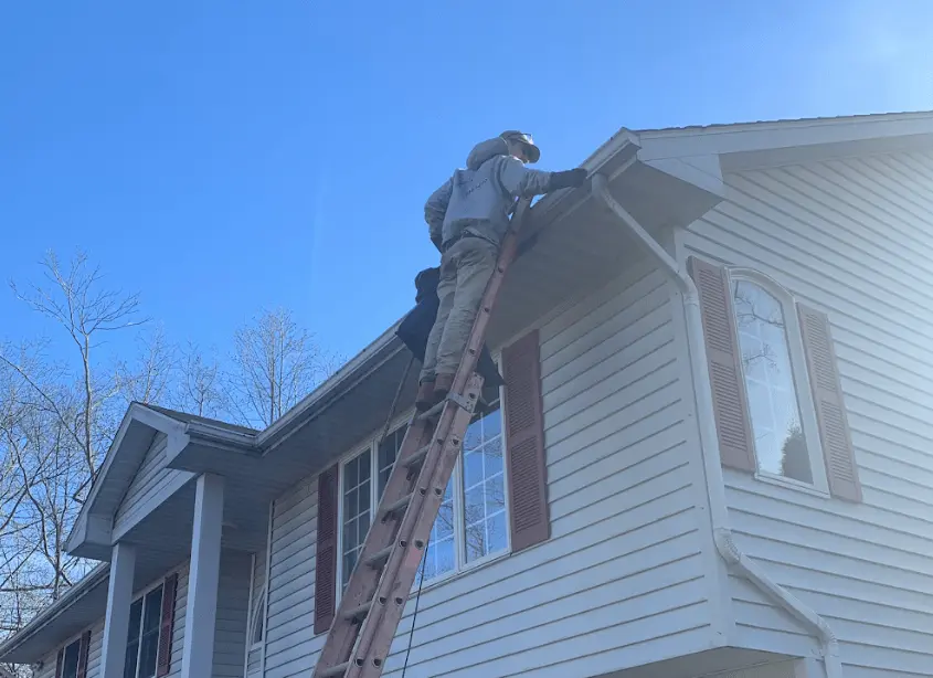 Gutter cleaning and maintenance being performed by Stow Power Washing in Stow